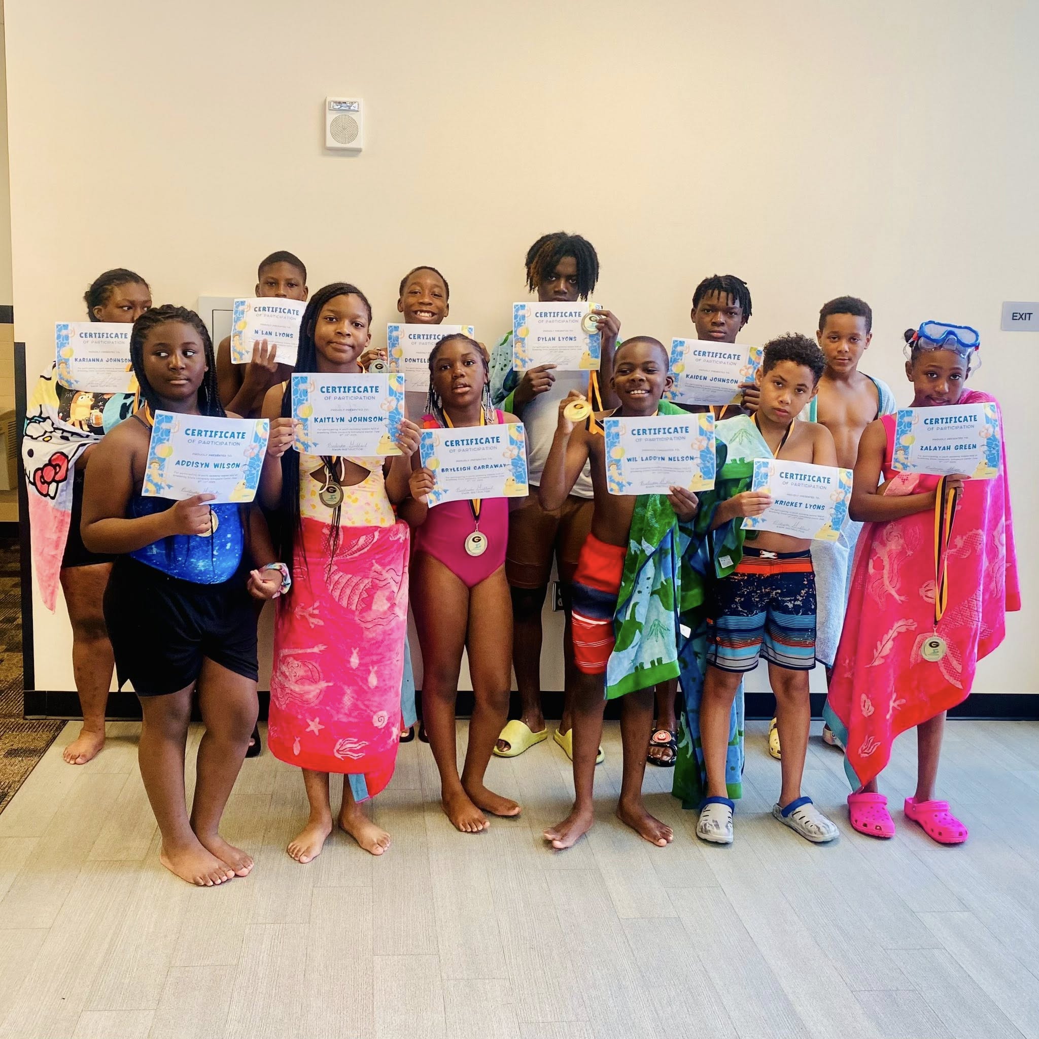 A group of kids holding certificates.